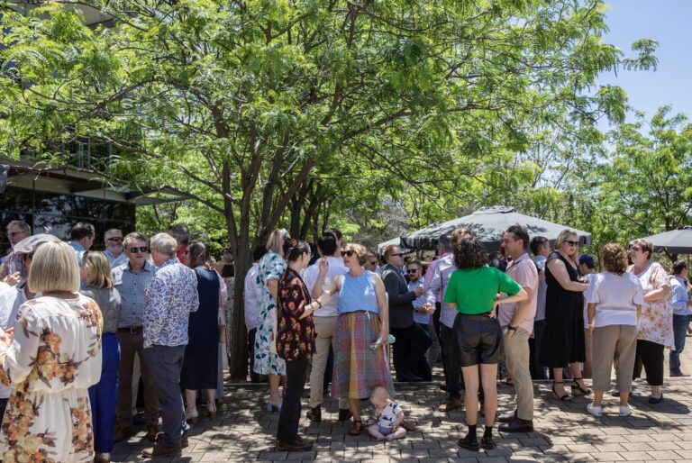 People stand under tree