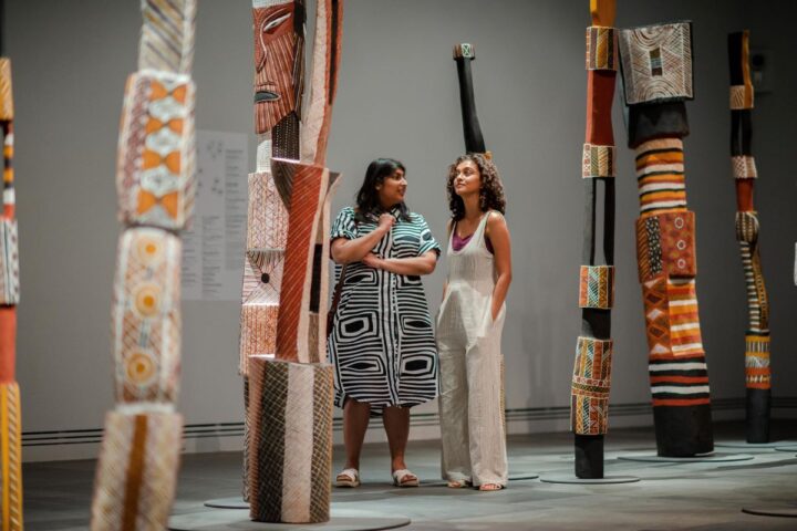 Two Aboriginal women admiring art.