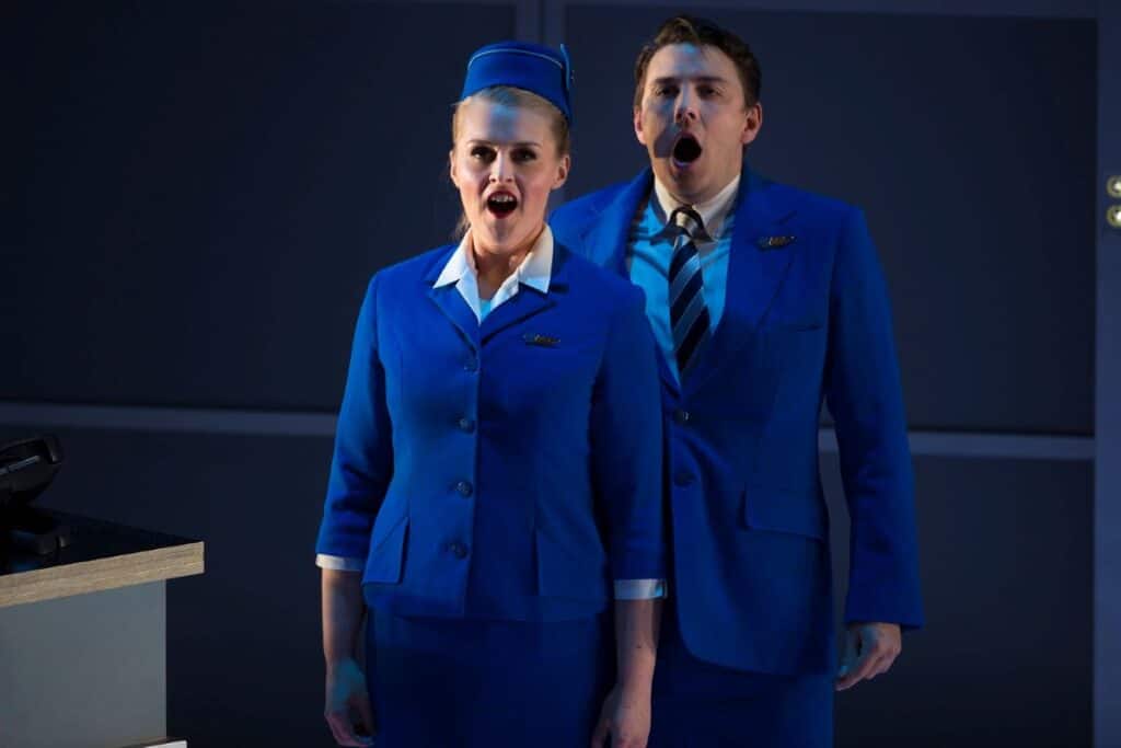 Actors Sioned Gwen Davies and Jonathan McGovern dressed in blue Flight Attendant uniforms in Flight. Source: James Glossop