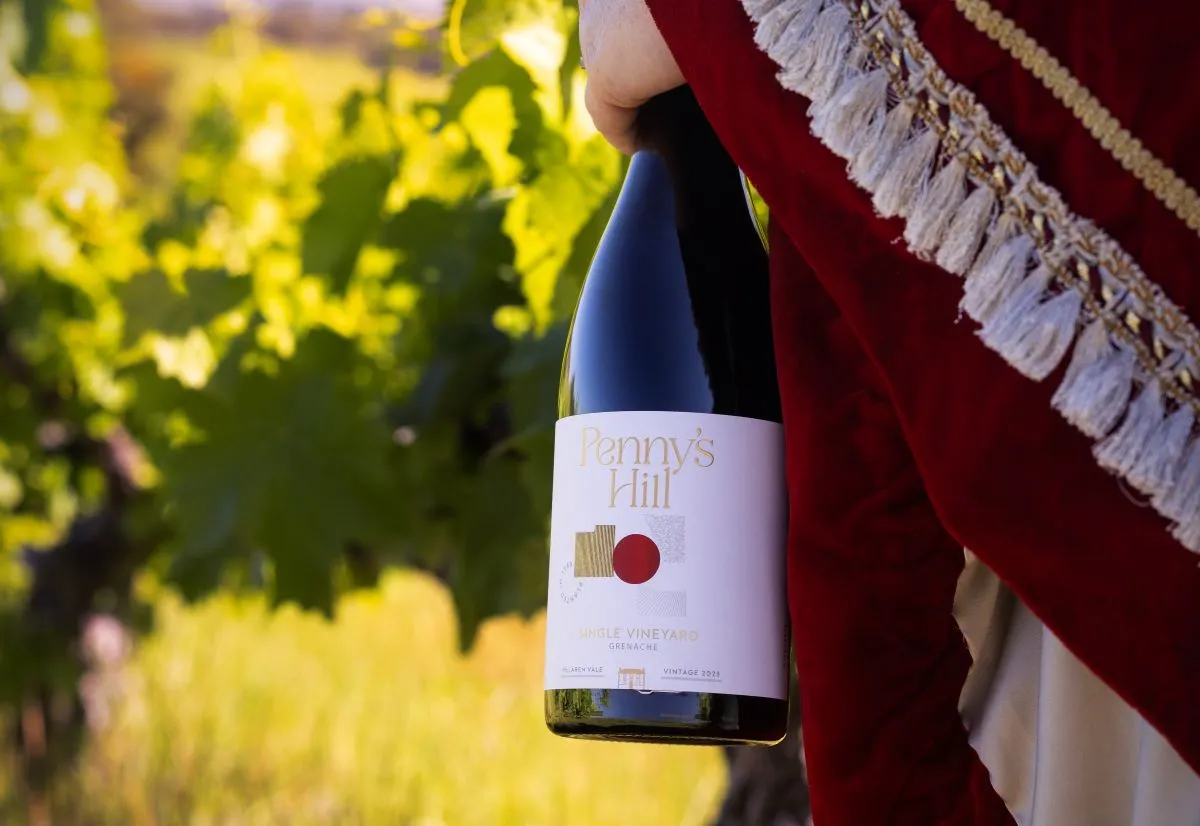 Close-up of someone holding Penny's Hill bottle of wine.