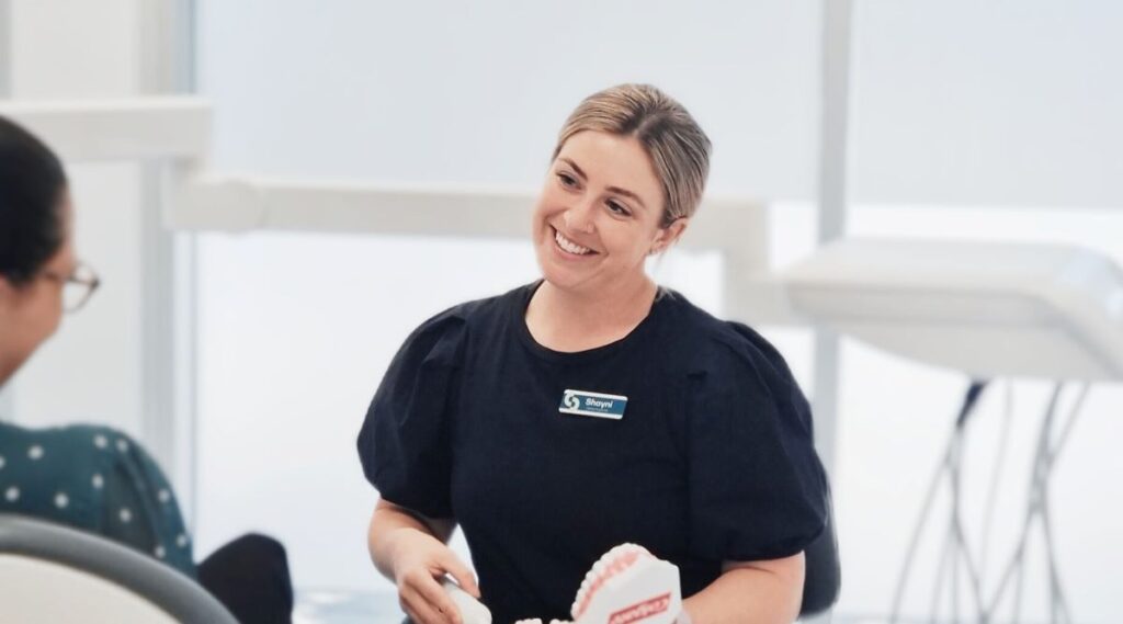 Woman smiles at client.