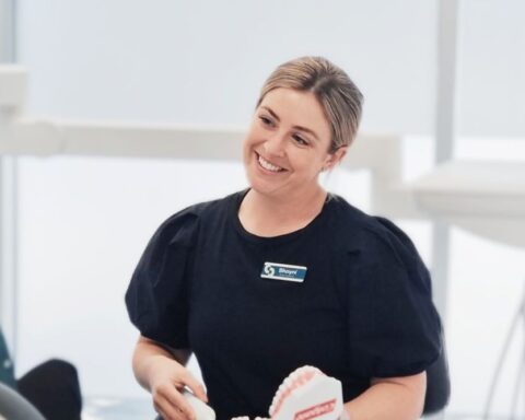 Woman smiles at client.