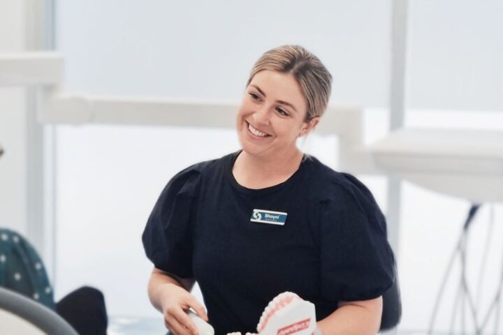 Woman smiles at client.