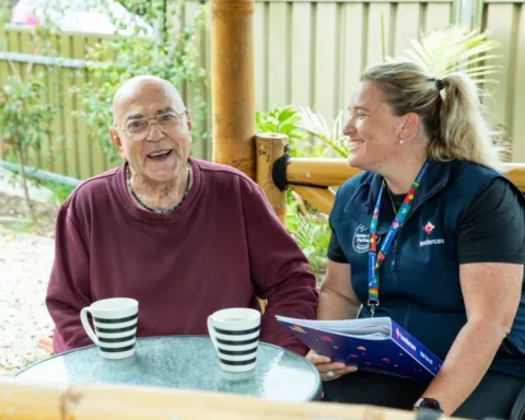 A man and woman enjoy coffee together at a table, engaged in conversation and sharing a moment.