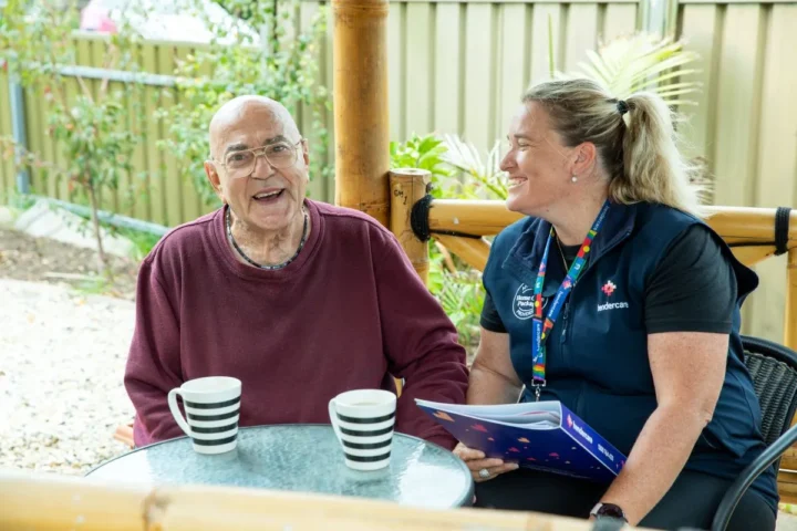 A man and woman enjoy coffee together at a table, engaged in conversation and sharing a moment.